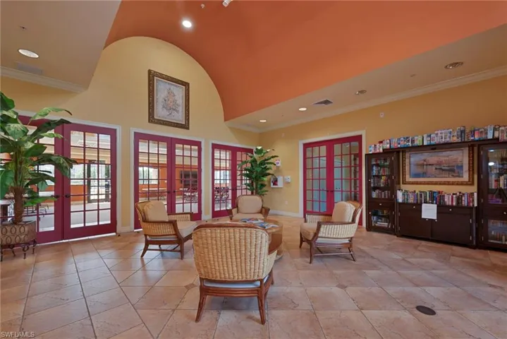 Sitting room featuring french doors, crown molding, recessed lighting, and high vaulted ceiling