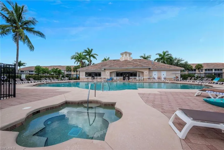 Community pool featuring a hot tub and a patio