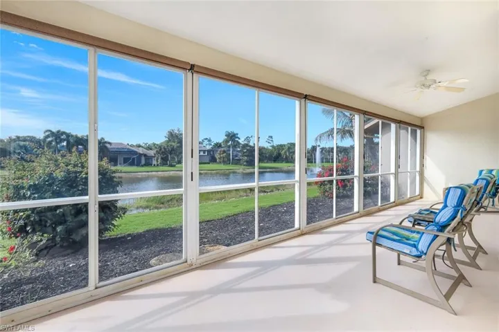 Unfurnished sunroom with lofted ceiling, a water view, and finished concrete flooring