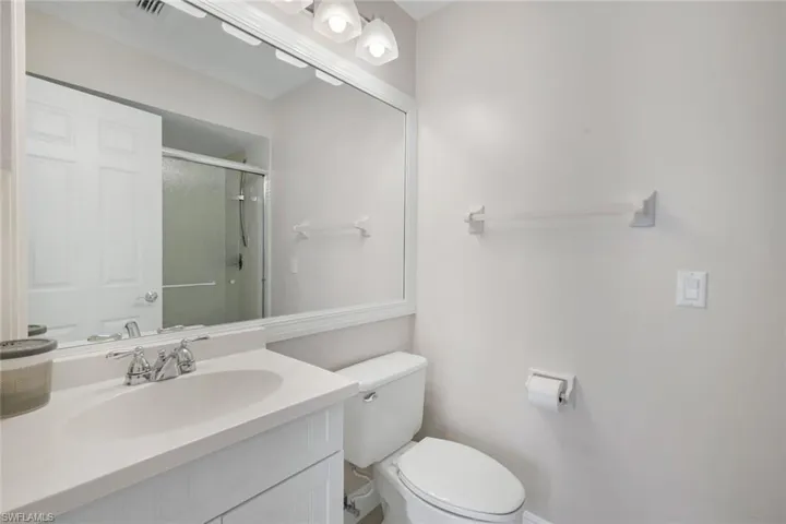 Bathroom featuring vanity and a shower stall