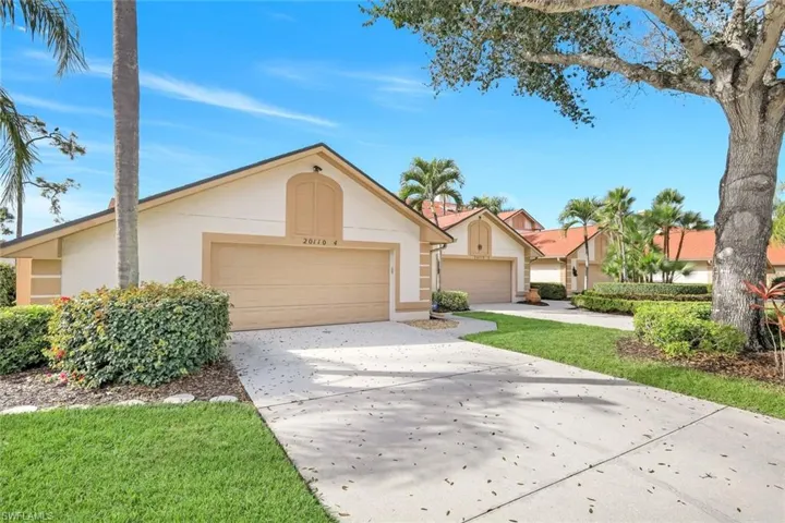 Ranch-style house with stucco siding and concrete driveway