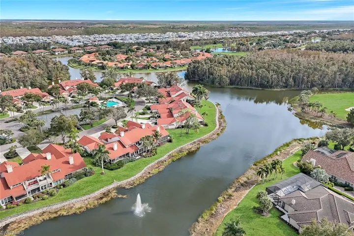 Aerial view of residential area featuring a nearby body of water