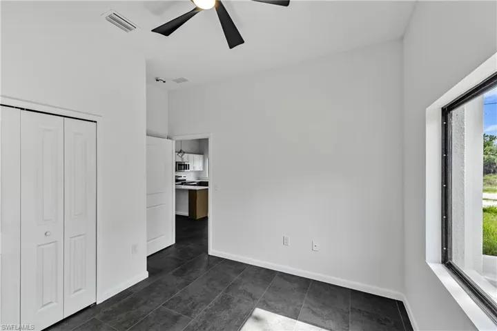 Interior space featuring dark tile flooring and a large window