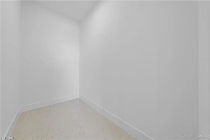 Unfurnished room with baseboards and light tile patterned floors