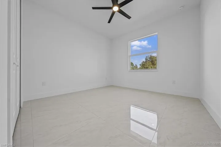 Unfurnished bedroom featuring ceiling fan and baseboards