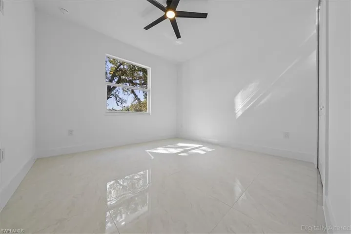 Unfurnished room with baseboards and ceiling fan