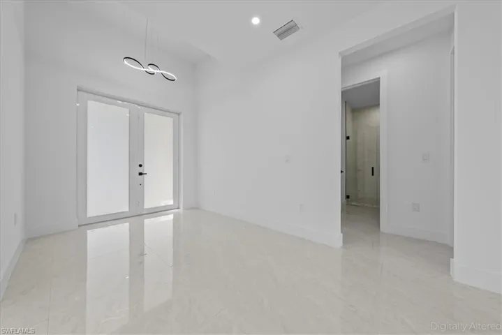 Spare room with french doors and recessed lighting