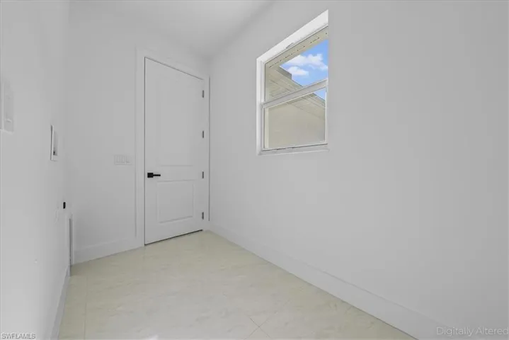 Spare room featuring baseboards