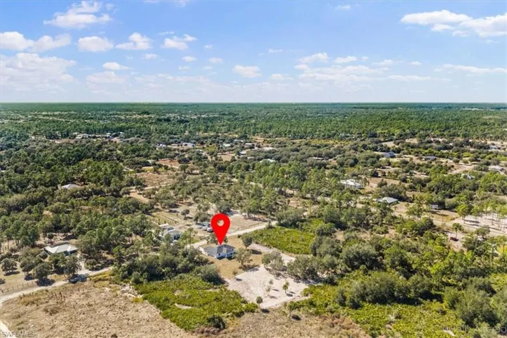 Aerial overview of property's location featuring a forest