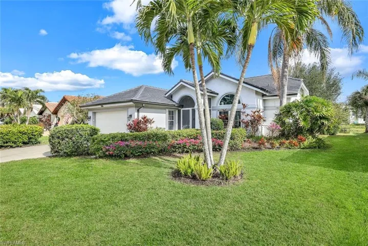 View of front of home with a front yard and a garage