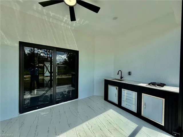 Screened lanai with outside kitchen.