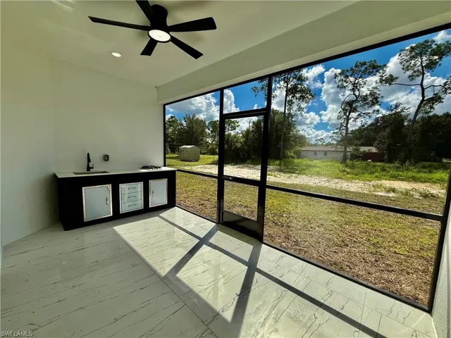 Screened lanai with outside kitchen.