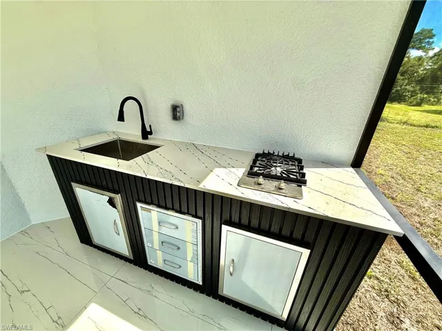 Screened lanai with outside kitchen.