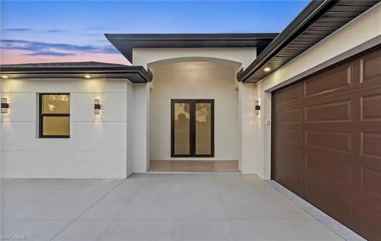 Contemporary exterior with a white stucco finish and dark trim accents