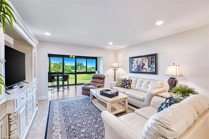 Living area featuring recessed lighting and light tile patterned floors