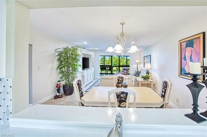 Dining room featuring a chandelier and baseboards