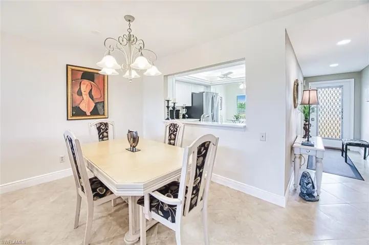 Dining space featuring a chandelier and light tile patterned flooring