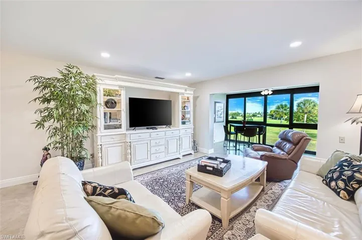 Living area featuring baseboards and recessed lighting