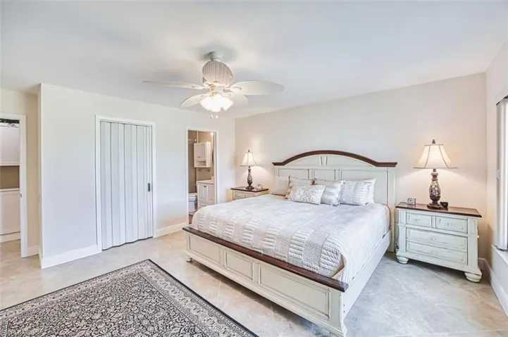 Master Bedroom with a ceiling fan, a closet, and ensuite bath