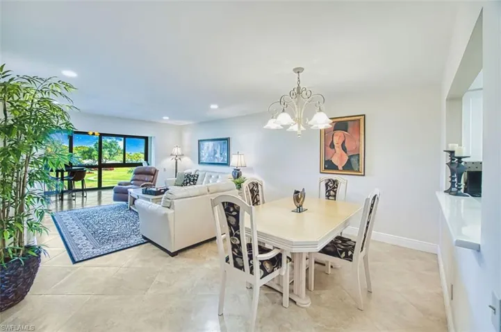 Dining space with hanging lights and light tile patterned floors