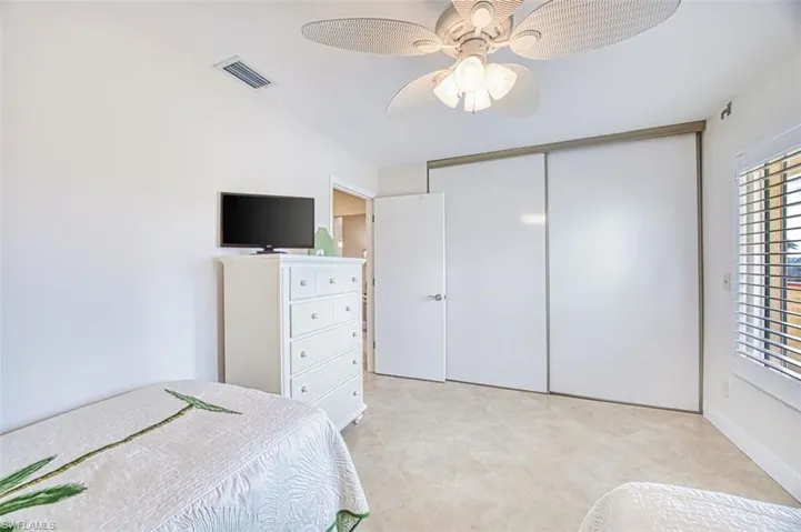 Bedroom featuring ceiling fan and a closet