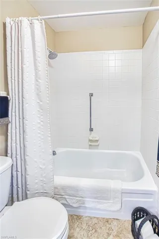 Bathroom with toilet and shower / tub combo