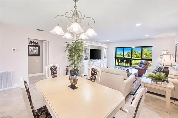 Dining space with suspended lighting and baseboards