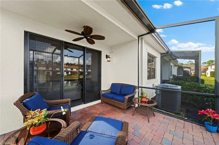 View of patio / terrace with glass enclosure, a ceiling fan, an outdoor living space, and cooling unit