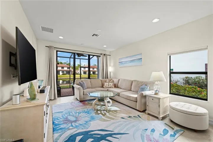 Living area with light tile patterned flooring, visible vents, and recessed lighting