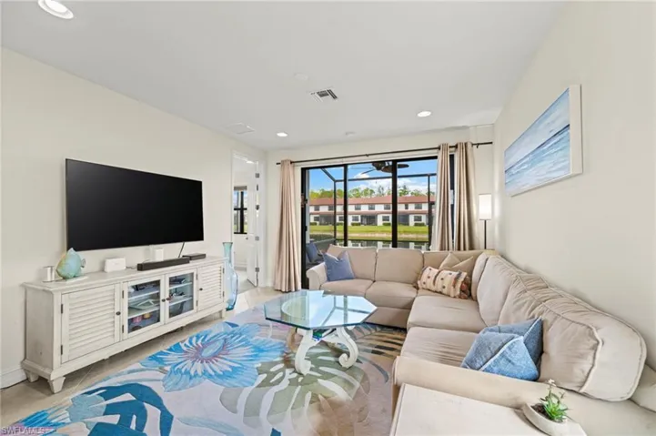 Living area with baseboards, light tile patterned flooring, visible vents, and recessed lighting
