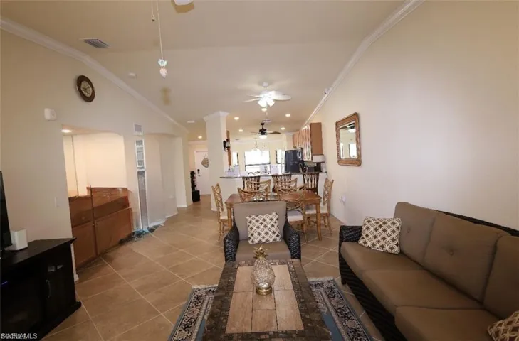 Living area featuring light tile patterned flooring, and ceiling fan