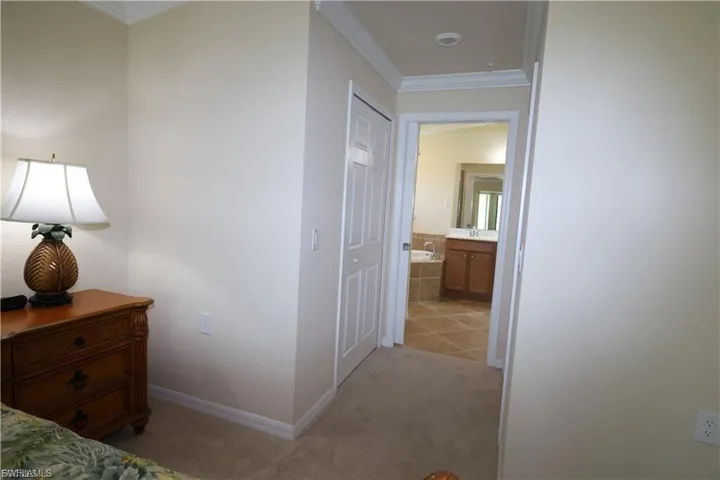 Hallway to walk in closets and primary bath