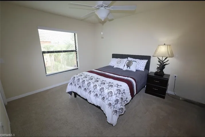 Guest Bedroom featuring a ceiling fan and carpet flooring