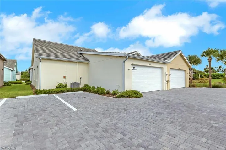 View of side of property with 2 Car Garage stucco siding