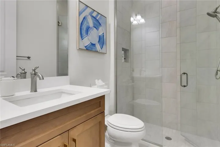 Guest bathroom with vanity and a shower stall