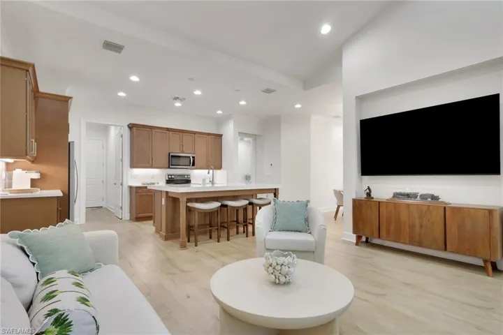 Living area featuring light wood finished floors and recessed lighting