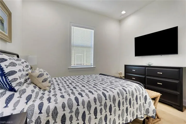 Guest Bedroom with recessed lighting and light wood finished floors