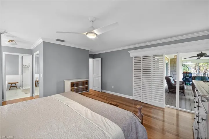 Hardwood flooring, painted gray walls, and crown molding