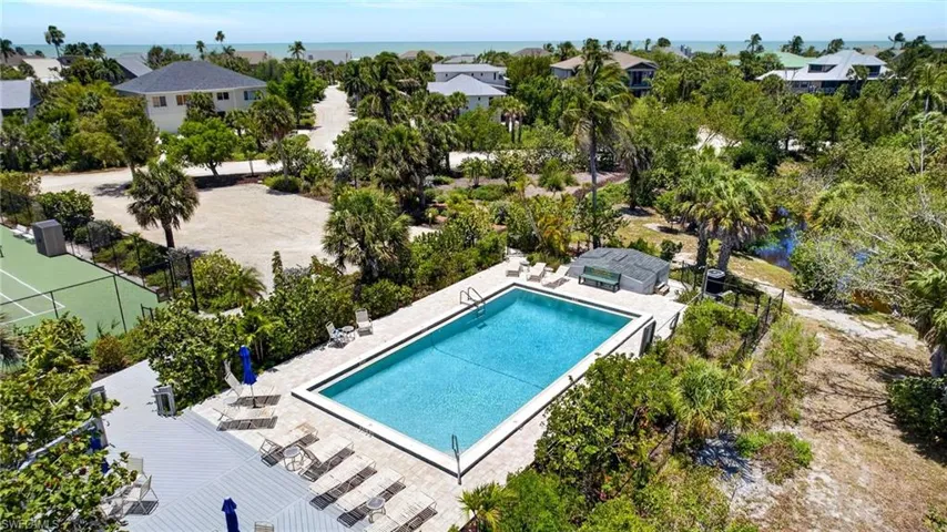 Outdoor Community swimming pool with integrated spa and surrounding paver deck
