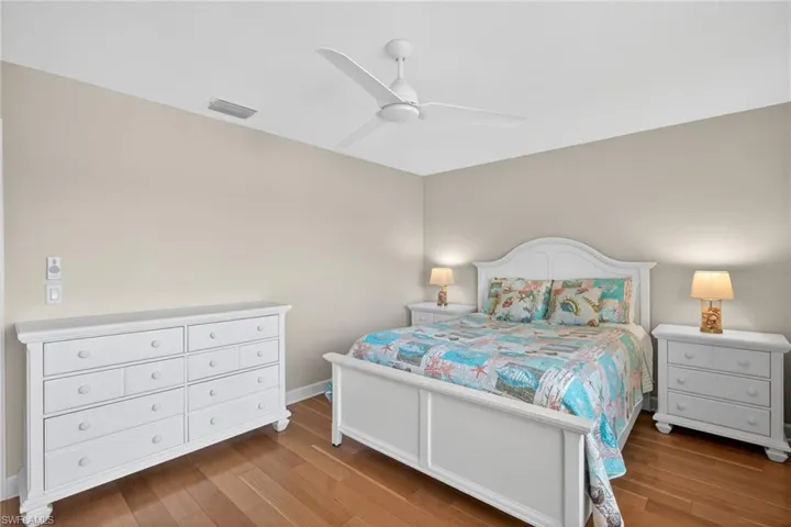 Bedroom featuring wood-finish flooring, a ceiling fan, and neutral wall tones