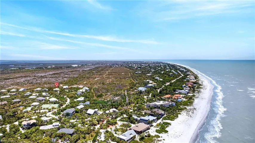 Coastal community with direct beach access, surrounded by lush natural landscaping and mature trees