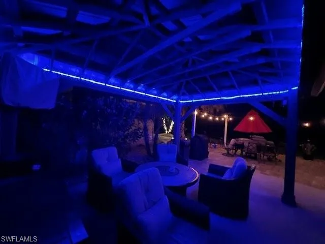 Patio at twilight with outdoor dining space, a gazebo, and a patio area