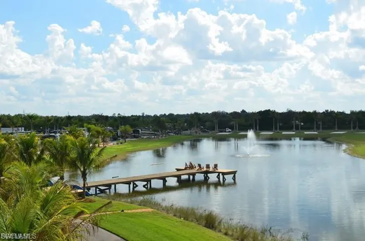 Dock area featuring a water view and a yard