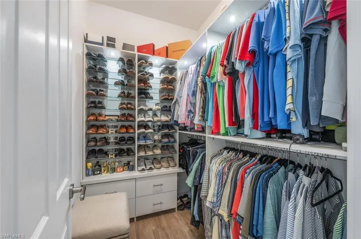 Walk in closet with wood finished floors
