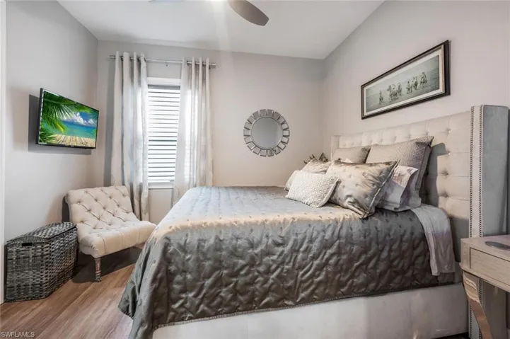 Bedroom with wood finished floors and ceiling fan
