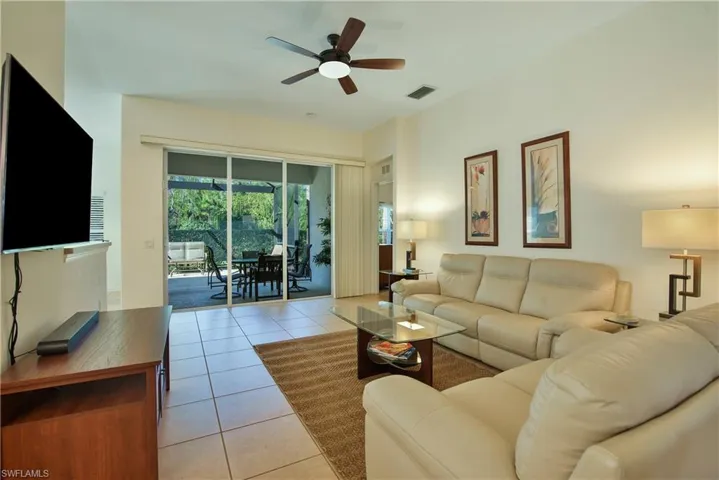 Living room featuring ceiling fan and light tile patterned flooring