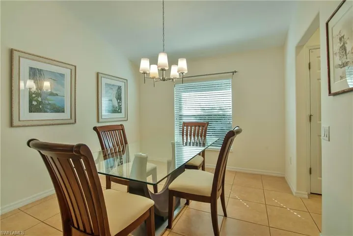 Dining room featuring light tile patterned floors and a chandelier
