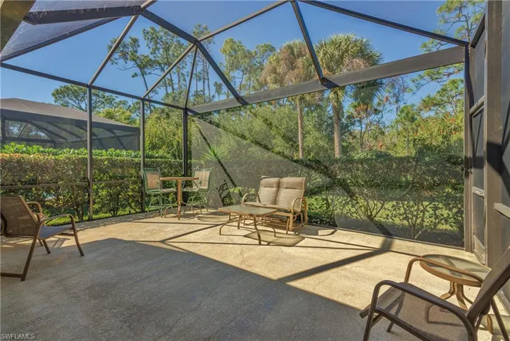 View of patio featuring glass enclosure and a sunroom