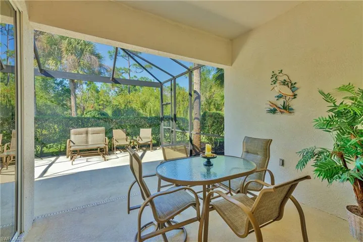View of patio featuring a sunroom and outdoor dining space
