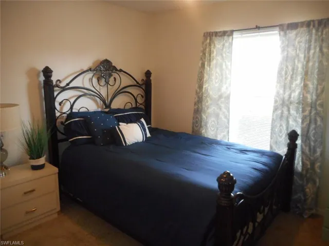 Bedroom with dark carpet